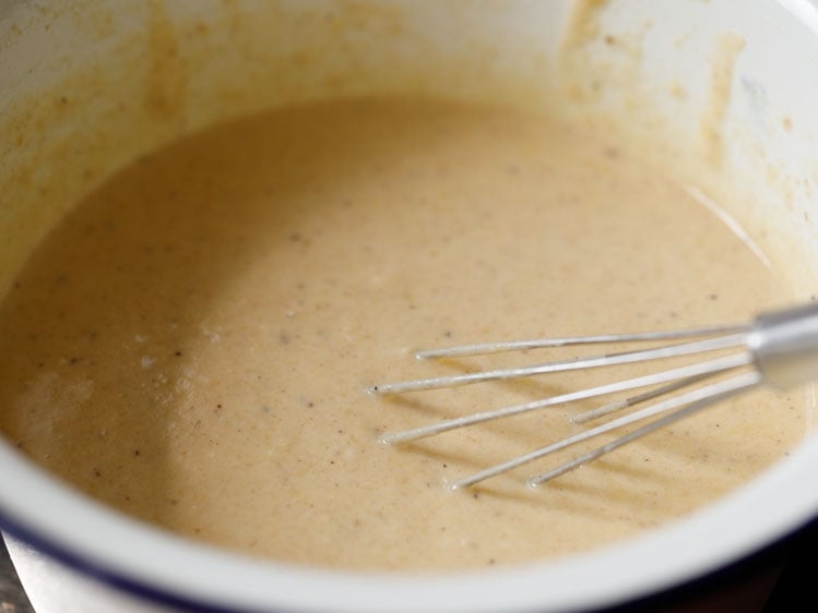 pumpkin pancake batter ingredients mixed with a whisk.