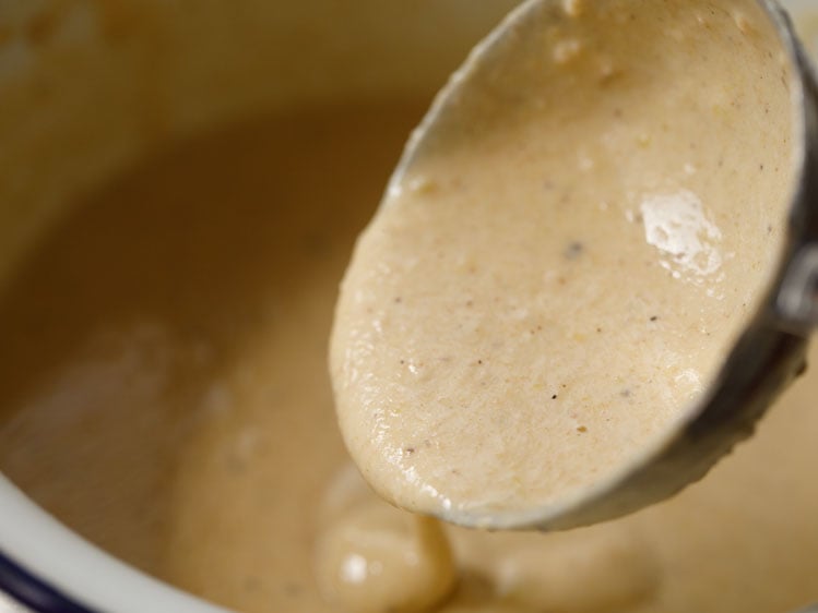 consistency of the batter being shown with a ladle.