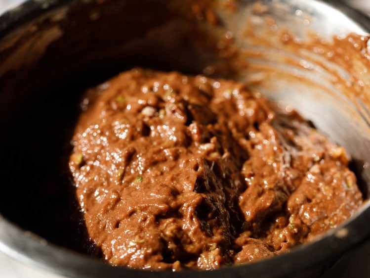 folded chocolate zucchini bread batter in the bowl