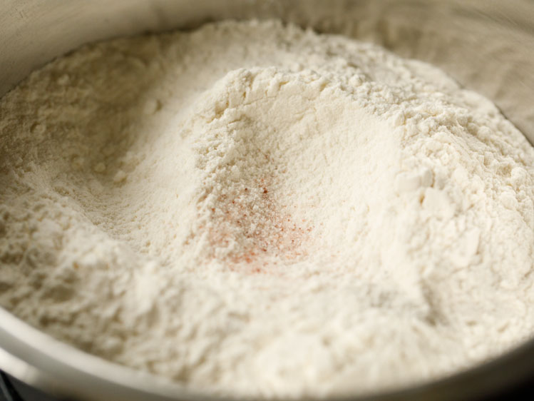 flour with a spot of pink himalayan sea salt in a silver mixing bowl