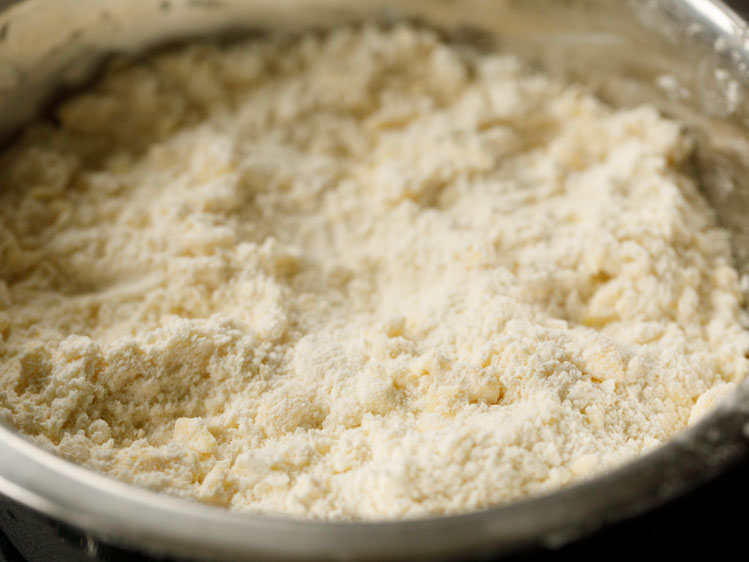 flour mix with butter cut in, illustrating the appropriate pea sized pieces of butter alongside sandy looking flour for homemade pie dough