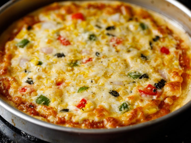assembling-veg-pizza9 veg pizza with gooey melted cheese out from the oven
