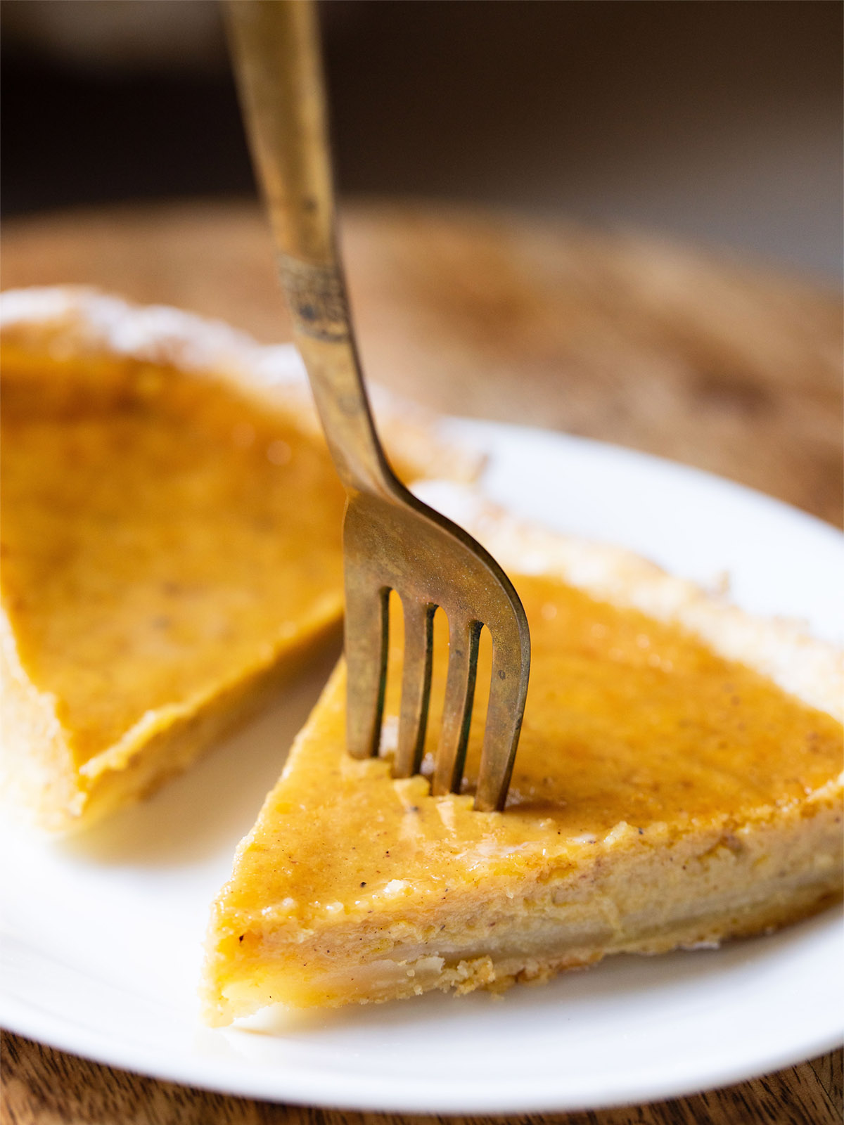 brass fork in a slice of easy eggless pumpkin pie