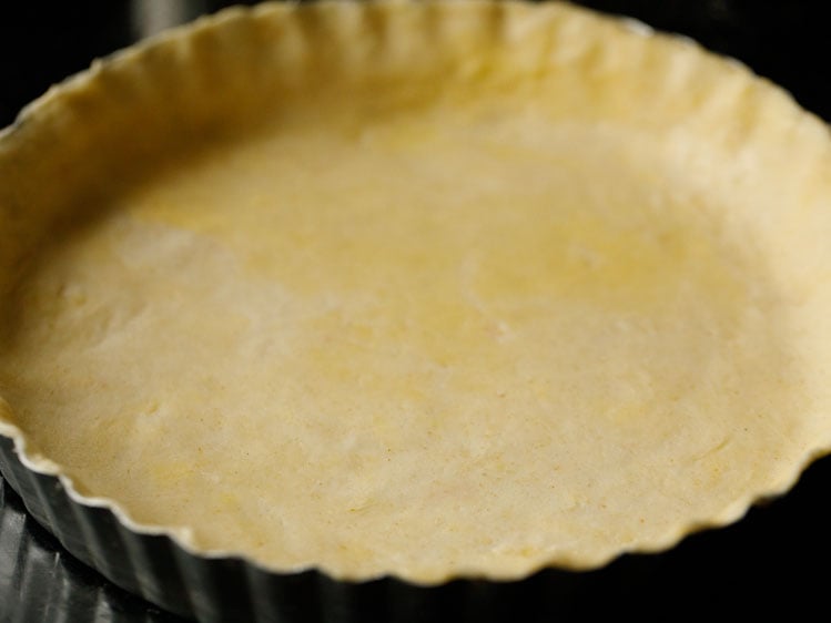 unbaked pie crust pressed into a fluted pie tin