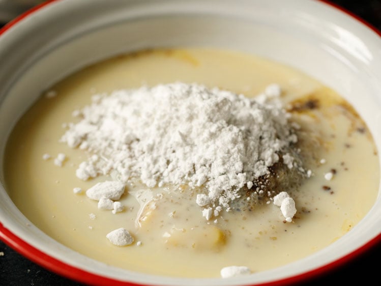 eggless pumpkin pie filling mix in a white bowl with condensed milk and arrowroot flour