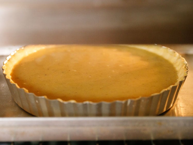 pumpkin pie baking in the oven