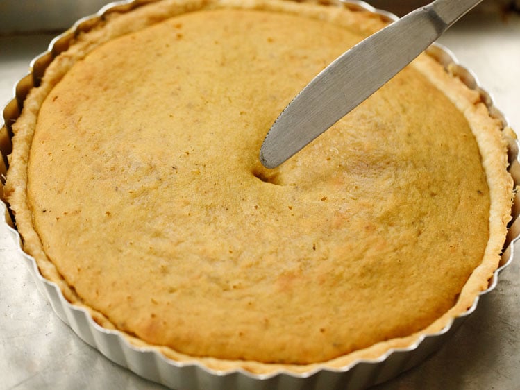 butter knife made a hole in the center of the eggless pumpkin pie to check for doneness