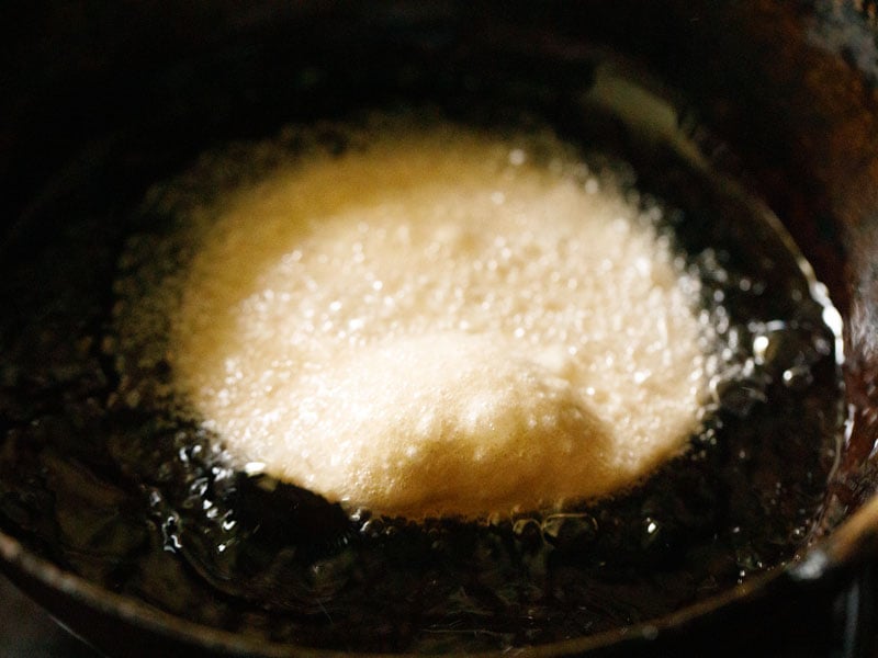 poori beginning to puff up in hot oil