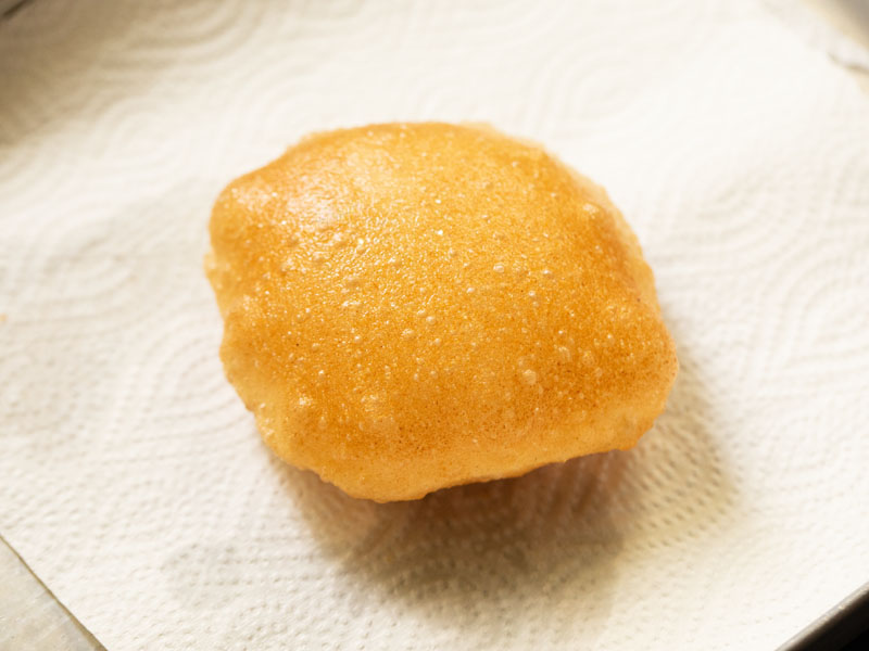 fried poori on a paper towel