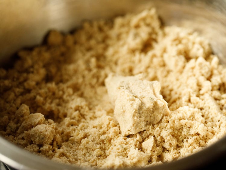 ghee and flour mixed together to a breadcrumb/sand consistency, and a piece of dough showing that the dough holds together when pressed