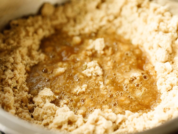 jaggery simple syrup added to ghee and flour mix