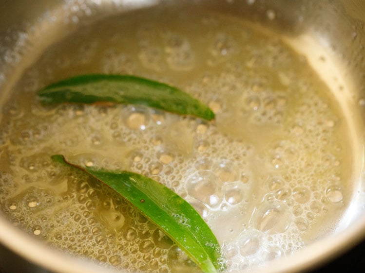 melted butter and bay leaves in steel pan