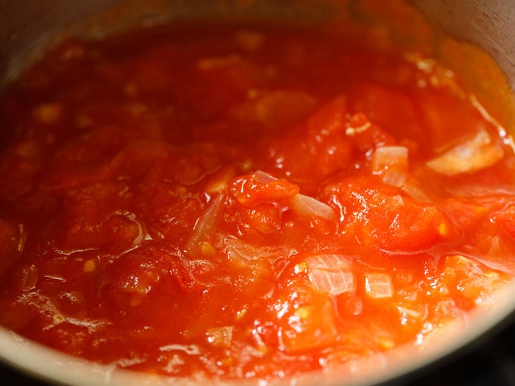 cooked onion, tomatoes added in a blender jar and bay leaves discarded
