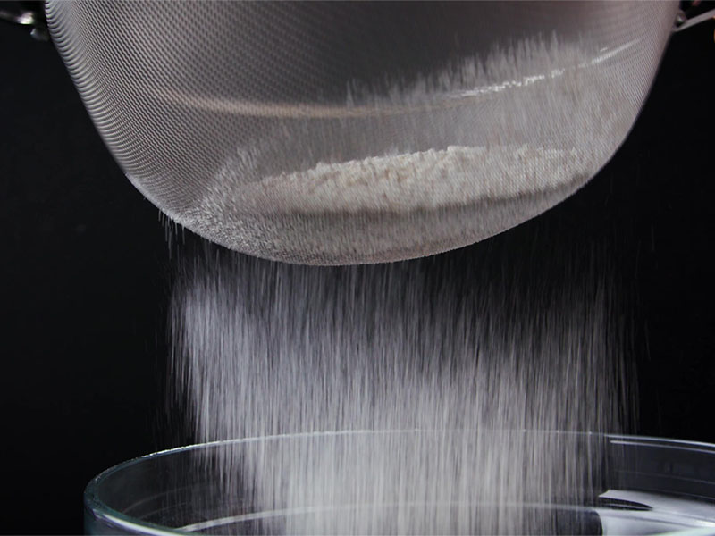 sifting dry ingredients in a bowl