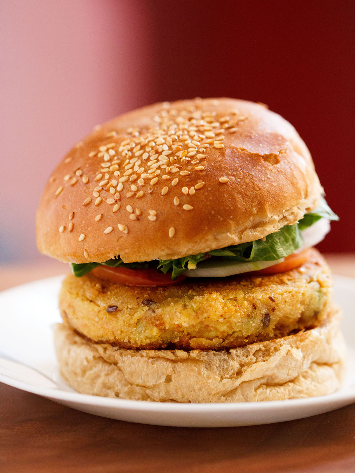 close up photo of burger on a white plate