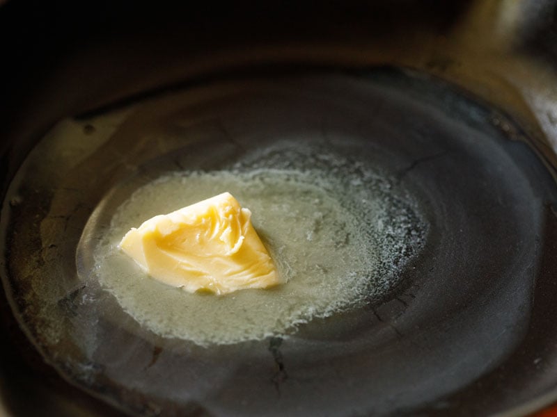 butter melting in a black skillet