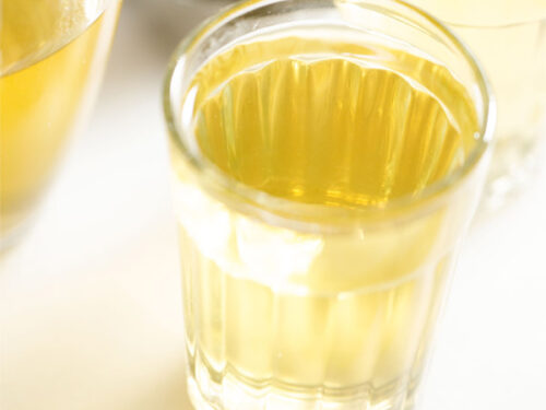 green tea in a transparent glass on a white marble board