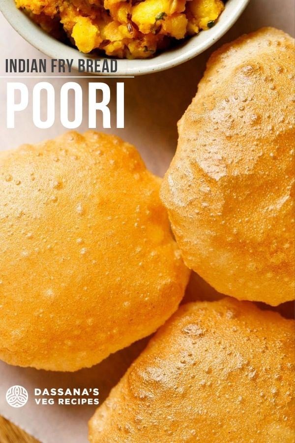 golden fried poori placed on white parchment paper