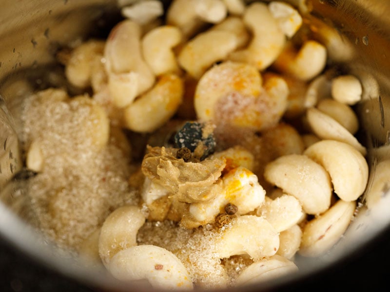 soaked raw cashews, salt, pepper, mustard, and turmeric in the bowl of a blender