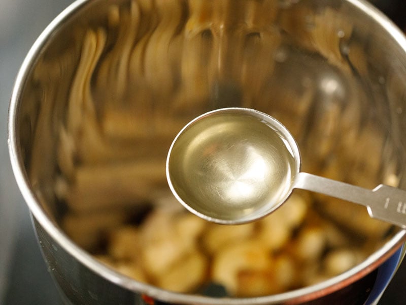 tablespoon filled with oil above the vegan mayo ingredients before they have been blended