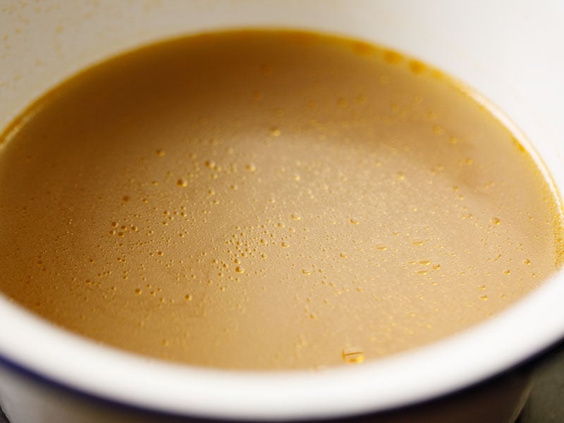 strained vegetable broth in a white bowl