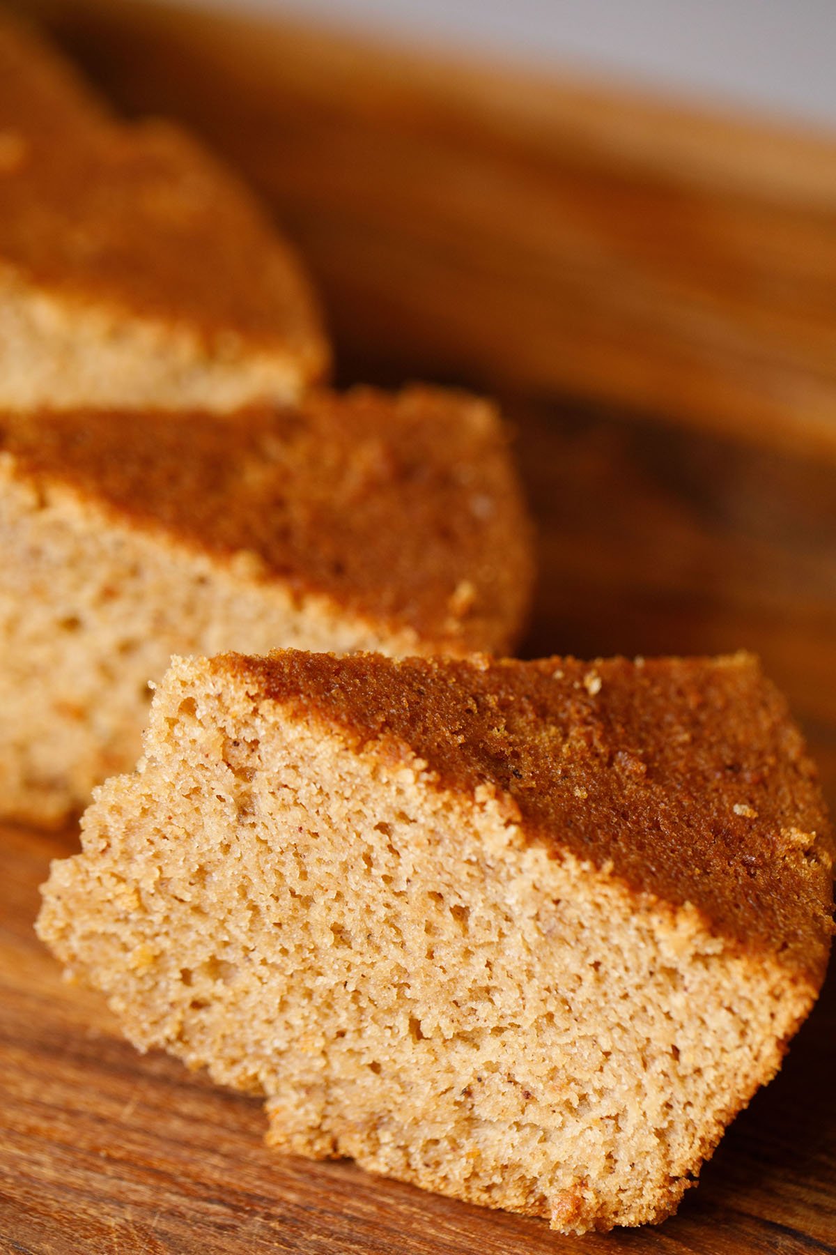 45 degree angle shot of triangular apple cake wedges showing the soft crumb