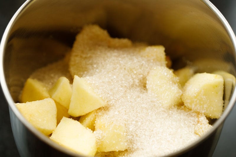 closeup shot of diced apples and sugar in bowl