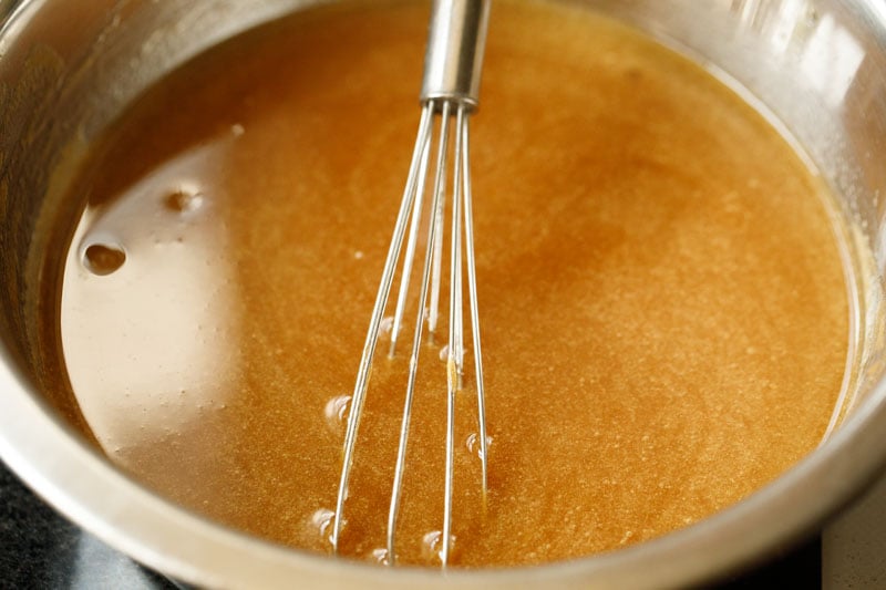 whisk mixing apple puree in the steel bowl