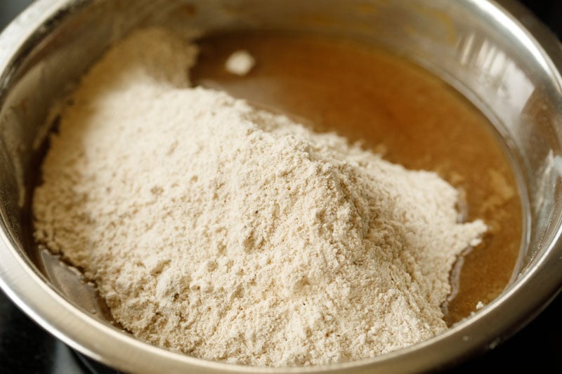 dry ingredients on top of apple puree in the steel bowl