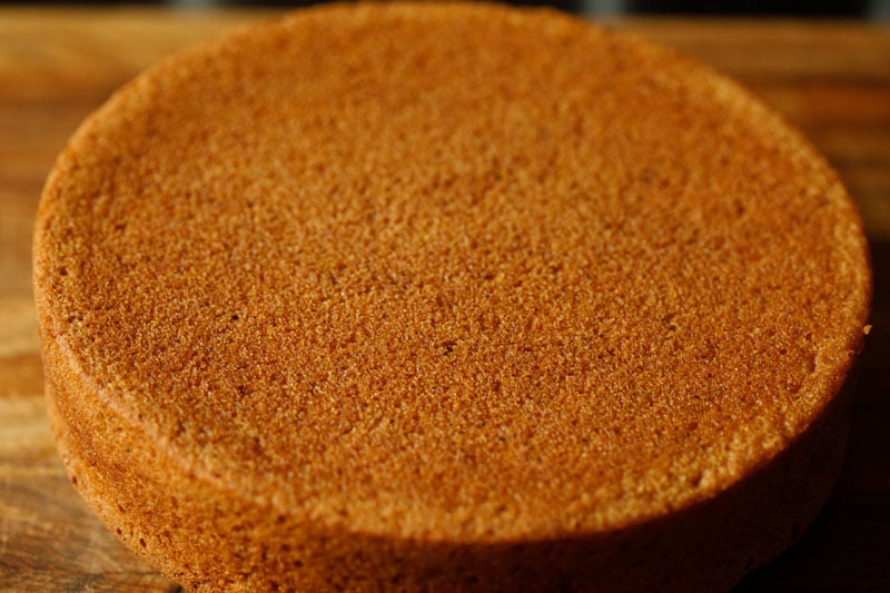 finished apple cake outside of baking dish on wooden board