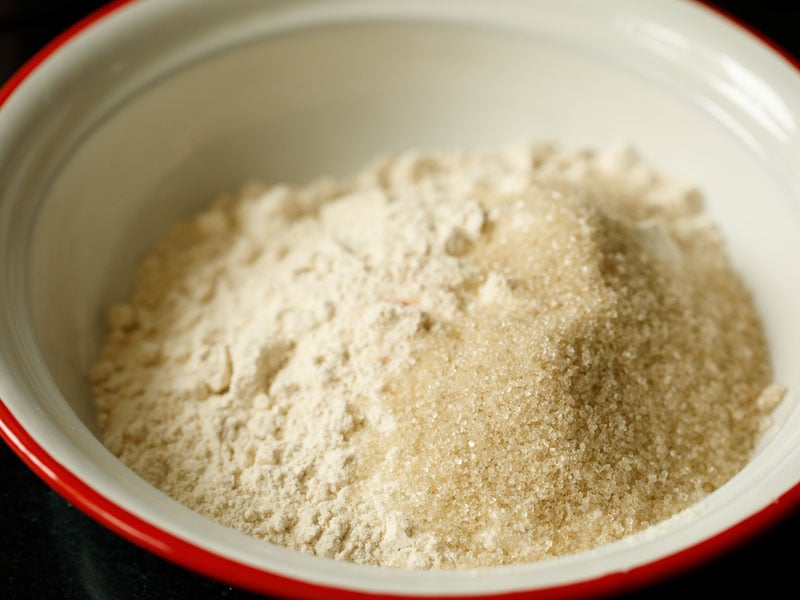 whole wheat flour, sugar and salt in a red and white mixing bowl