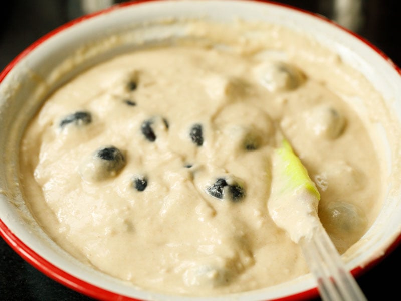 spatula folding blueberries into vegan pancake batter