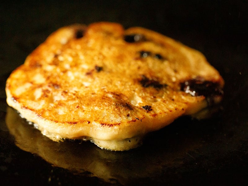 finished homemade vegan blueberry pancake on a black skillet