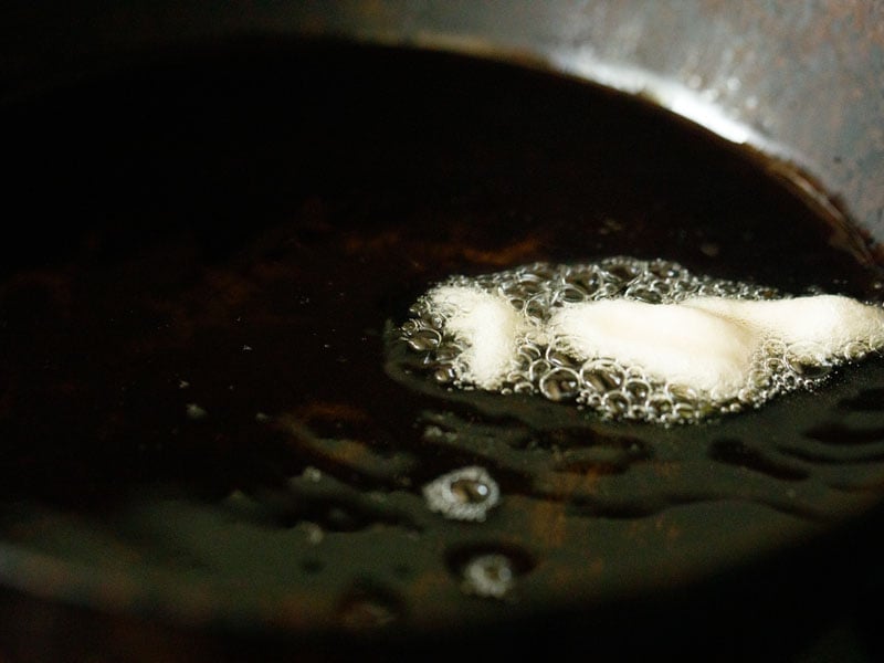 a few batter droplets being fried in hot oil