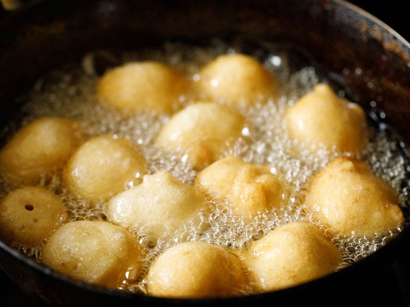 lightly golden vada frying in hot oil