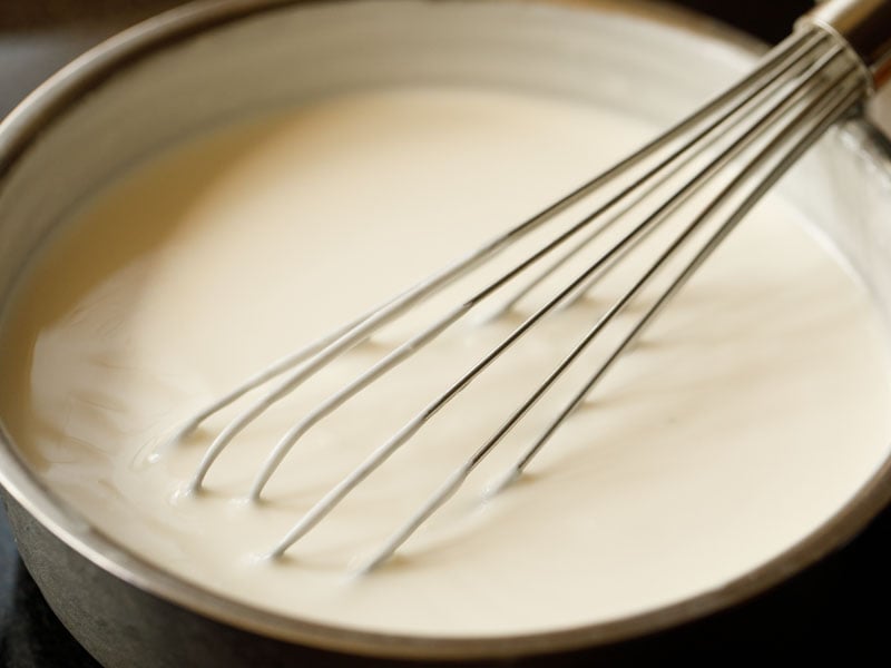 yogurt being whisked with a wire whisk