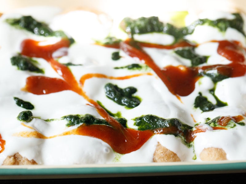 dahi vada topped with chutneys