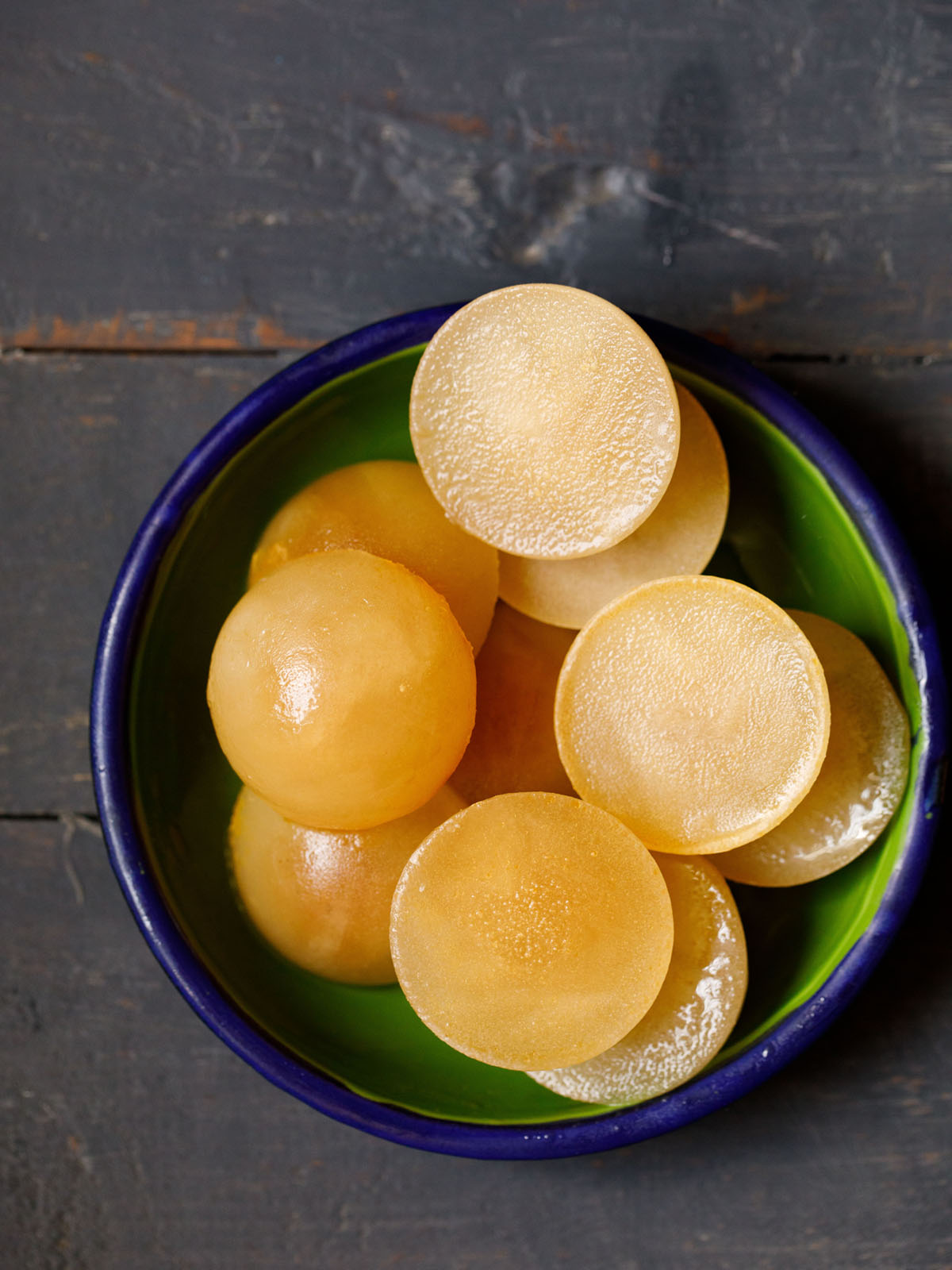 frozen round veg stock cubes in a green enameled bowl