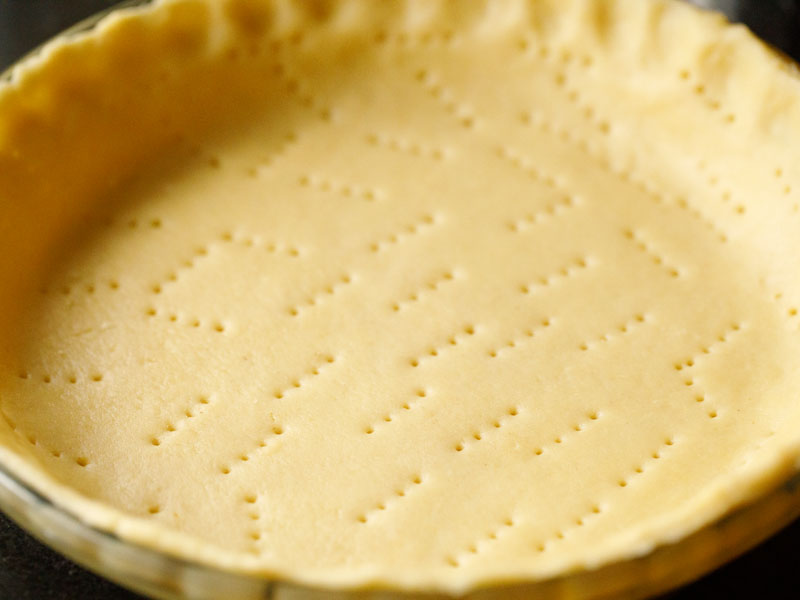 pie crust that has been pierced with a fork prior to blind baking