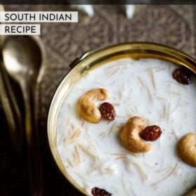 semiya payasam garnished with cashews and raisins in a brass bowl on a brass tray with small brass spoons and white flower on the tray and text layover.