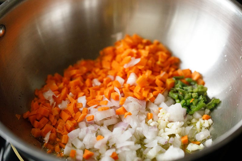chopped onions, carrots, garlic and celery in a steel frying pan