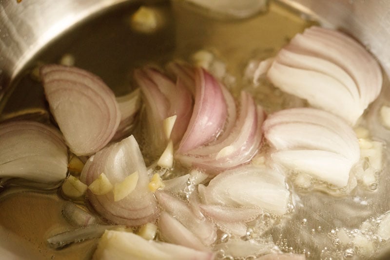 sliced onions sautéing in oil