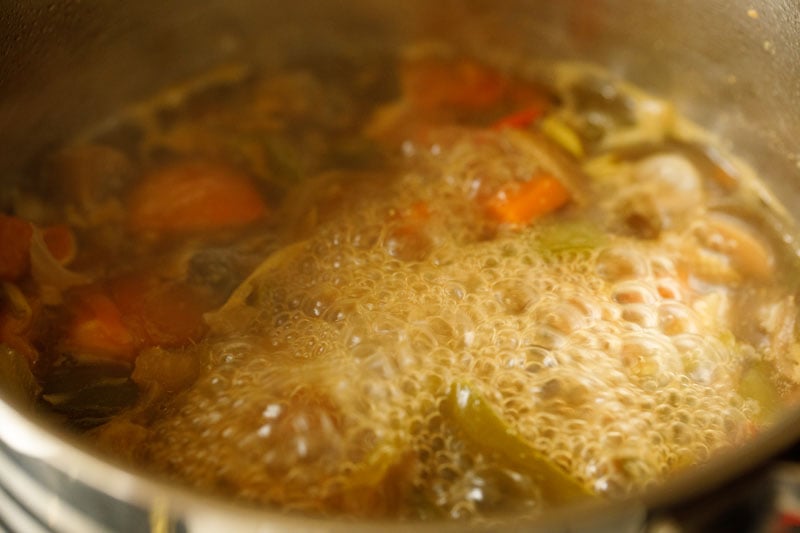 vegetable tom kha soup simmering on stovetop prior to adding coconut milk