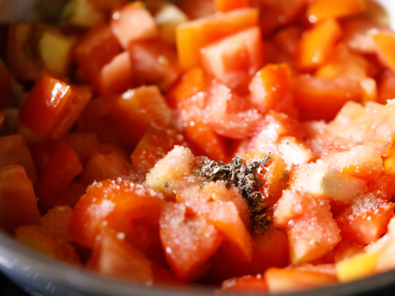 fresh tomato cubes, salt and pepper added to skillet