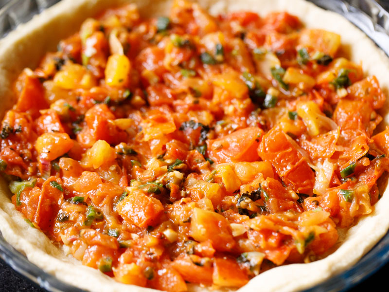 tomato filling added to pie crust on top of cheddar