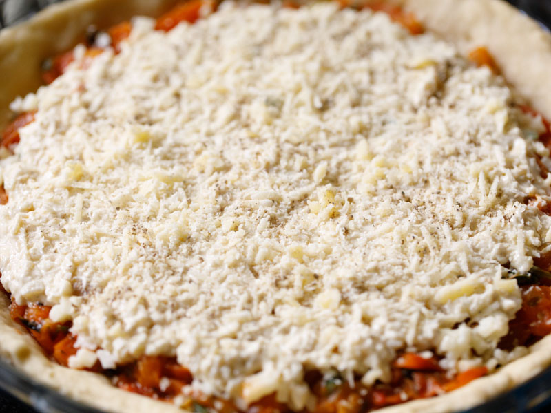 grated vegetarian parmesan sprinkled atop mayo-cheese mixture on unbaked tomato pie