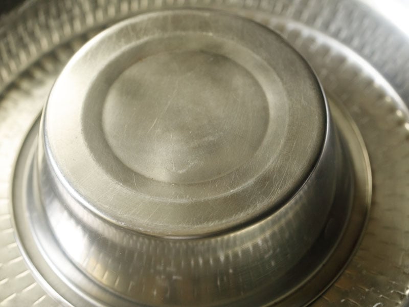 dough covered with a large steel bowl 