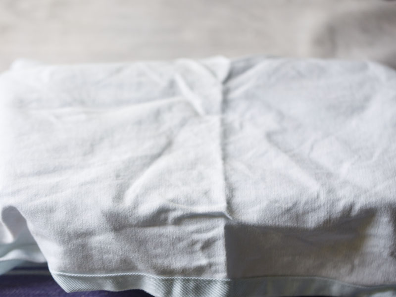 loaf pan covered with a light blue napkin