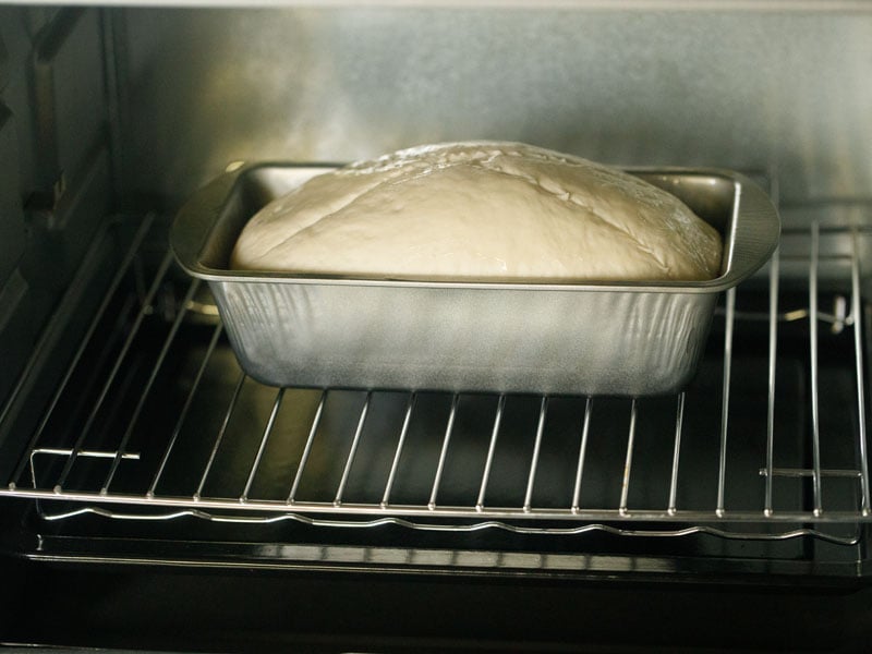 loaf pan with the dough loaf in the oven 