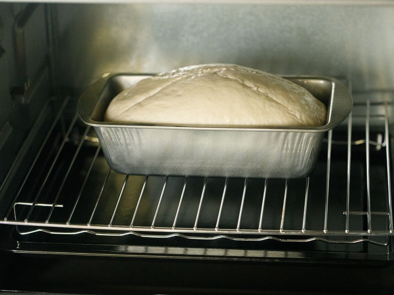 loaf pan with the dough loaf in the oven